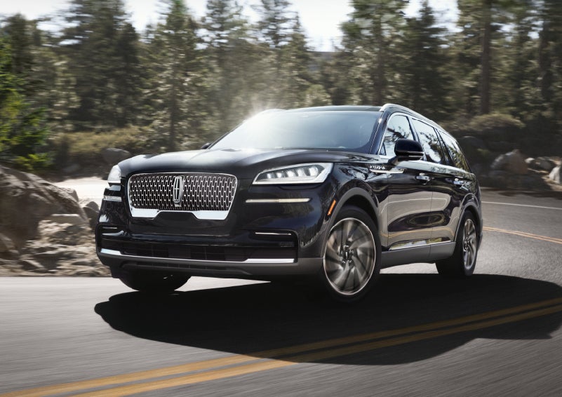 A Lincoln Aviator® SUV is being driven on a winding mountain road | Lincoln Demo 4 in Wooster OH
