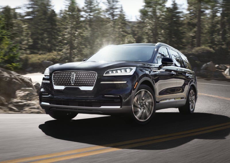 A Lincoln Aviator® SUV is being driven on a winding mountain road | Lincoln Demo 4 in Derwood MD