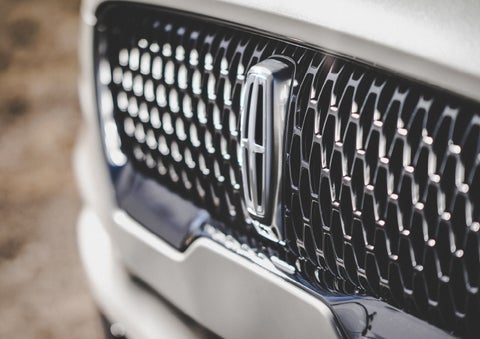 The grille of the 2024 Lincoln Aviator® Reserve model with an eye-catching repeated field of Lincoln Star logo shapes | Lincoln Demo 4 in Wooster OH