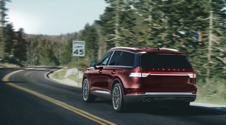 A 2024 Lincoln Aviator® SUV is being driven on a winding mountain road | Lincoln Demo 4 in Wooster OH