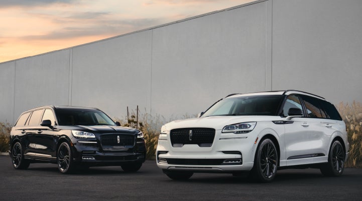Two Lincoln Aviator® SUVs are shown with the available Jet Appearance Package | Lincoln Demo 4 in Wooster OH