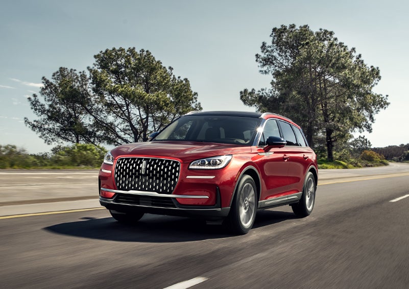 A 2024 Lincoln Corsair® SUV is shown being driven on a country road. | Lincoln Demo 4 in Wooster OH