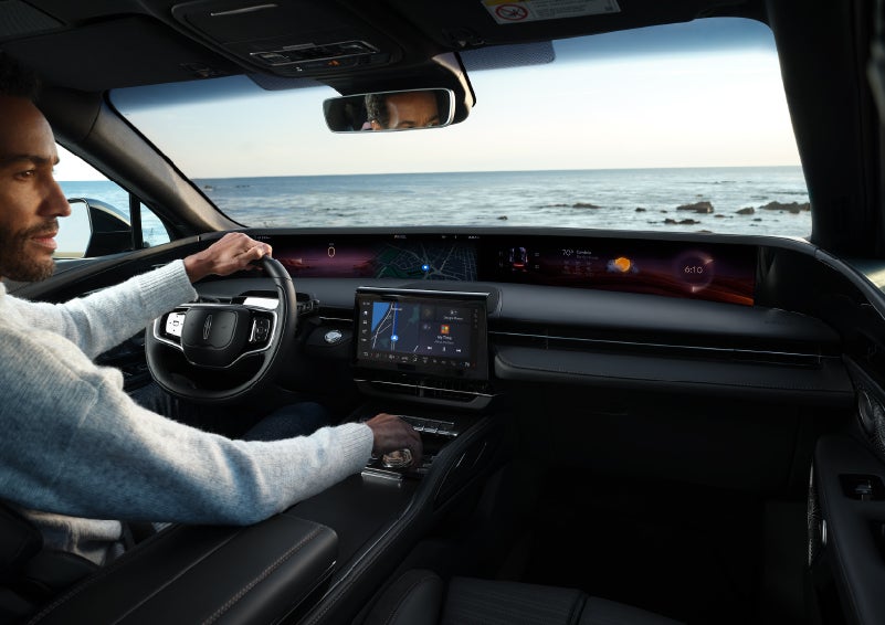 A driver of a parked 2024 Lincoln Nautilus® SUV takes a relaxing moment at a seaside overlook while inside his Nautilus. | Lincoln Demo 4 in Wooster OH