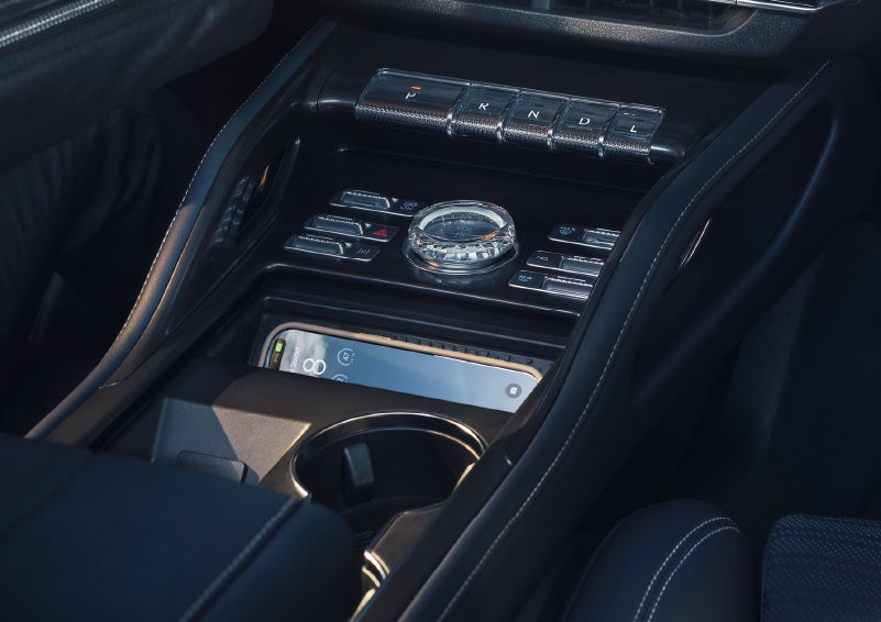 A smartphone is shown charging in the wireless charging pad. | Lincoln Demo 4 in Wooster OH