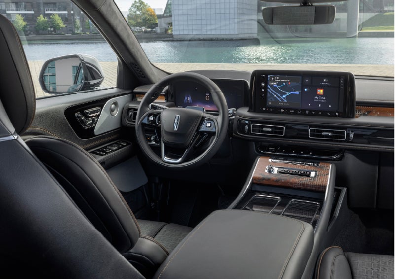 The interior of the 2026 Lincoln Aviator® SUV is shown parked with a view of a harbor through the windshield. | Lincoln Demo 4 in Derwood MD